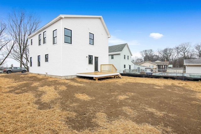 rear view of property with a wooden deck