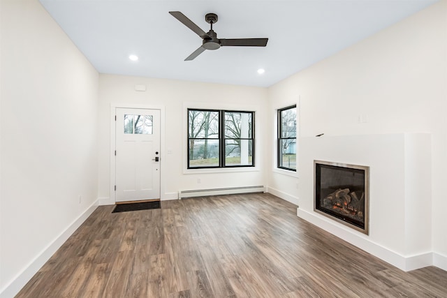 entrance foyer with a baseboard heating unit, wood-type flooring, and ceiling fan