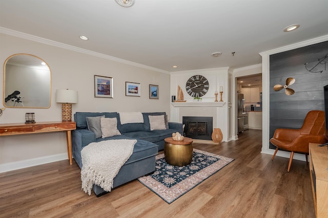 461 Ocean Blvd Unit A7, Hampton, NH 03842 - living area with wood finished floors, ornamental molding, a fireplace, recessed lighting, and baseboards