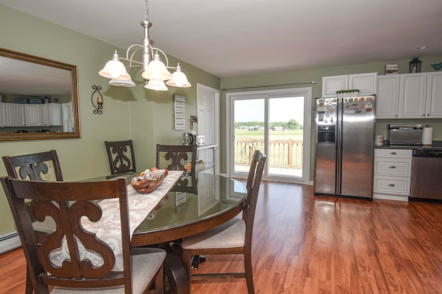 dining space featuring a notable chandelier and wood-type flooring