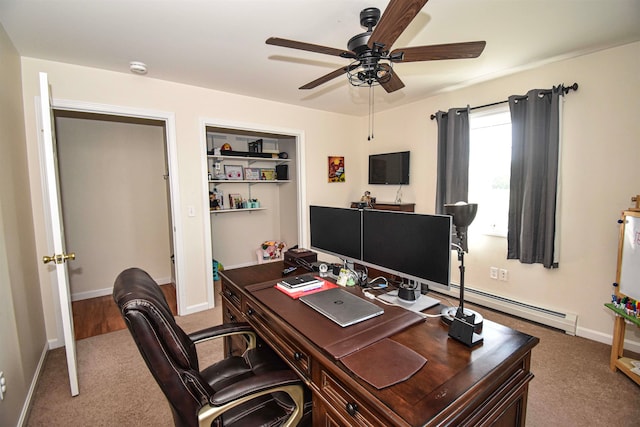 office space with carpet floors, a baseboard radiator, and ceiling fan