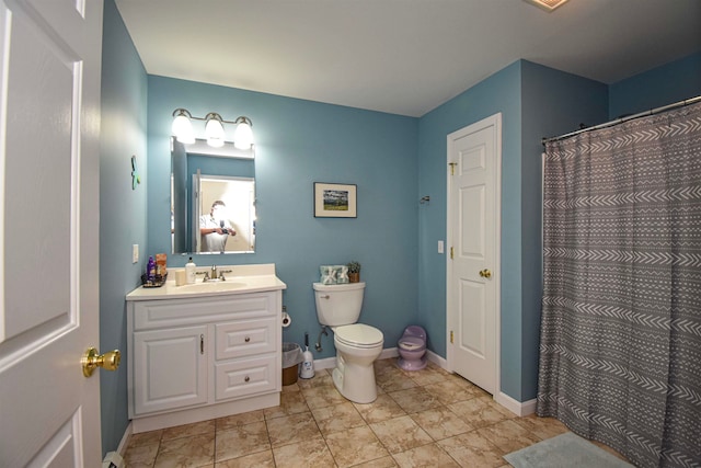 bathroom with vanity, curtained shower, and toilet