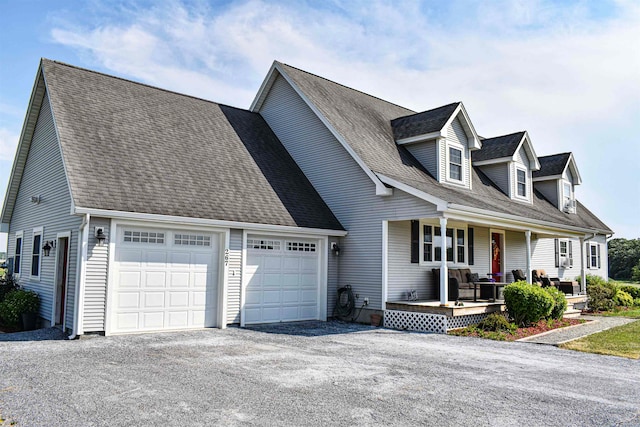 cape cod home featuring a garage and a porch