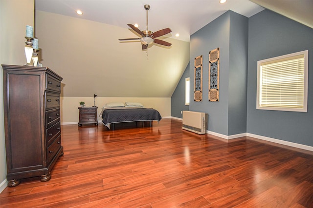 bedroom with hardwood / wood-style floors, vaulted ceiling, and ceiling fan