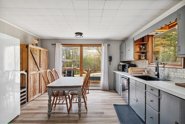 kitchen featuring gray cabinets, dishwasher, and sink