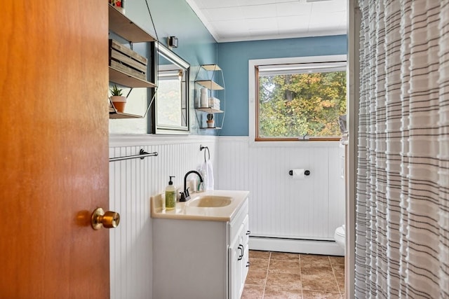 bathroom with vanity, walk in shower, baseboard heating, and toilet