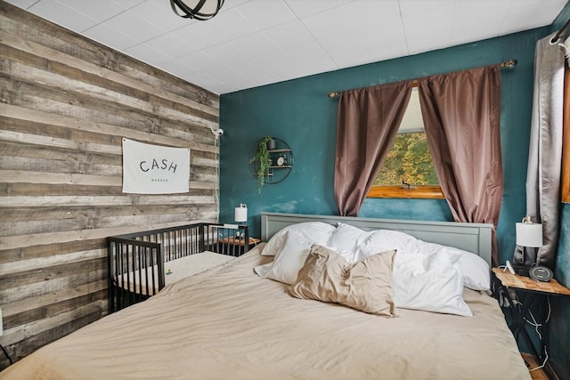 bedroom with wood walls