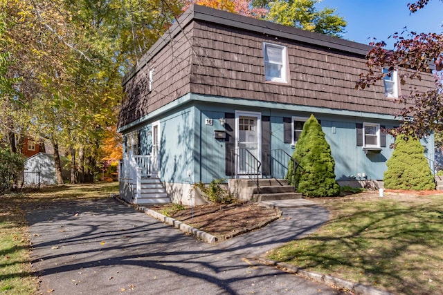 view of front of home featuring a shed