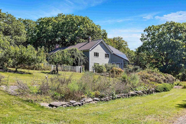 view of property exterior featuring a lawn