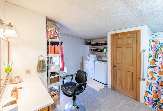 kitchen featuring a textured ceiling and washer and clothes dryer