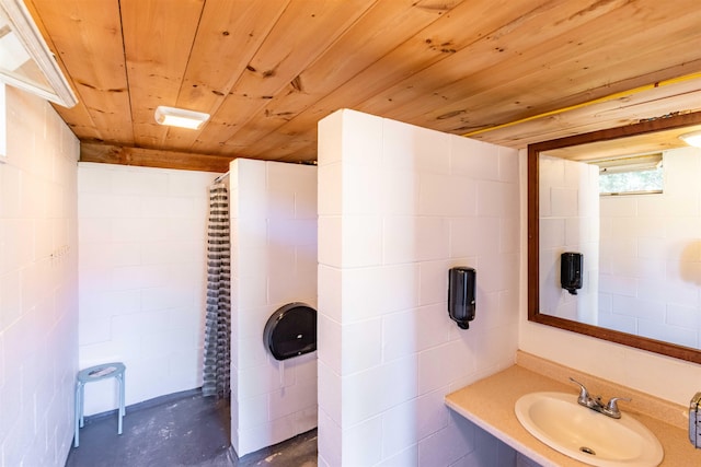 bathroom with wooden ceiling, sink, and concrete flooring