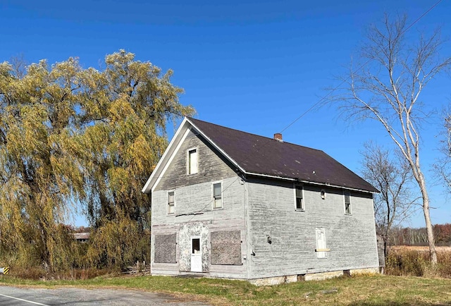 view of property exterior featuring a chimney