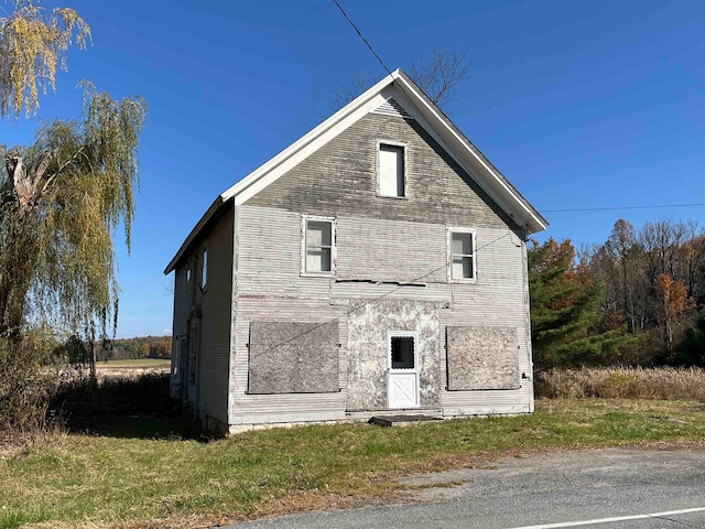 view of side of home with a yard