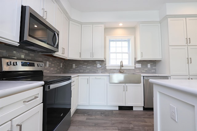 kitchen featuring backsplash, stainless steel appliances, dark hardwood / wood-style floors, and white cabinets