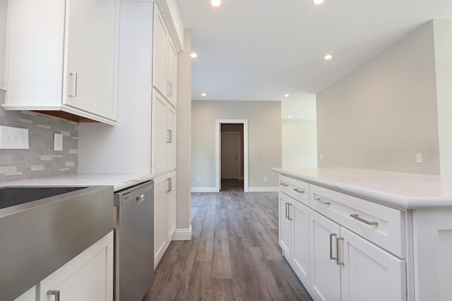 kitchen with decorative backsplash, white cabinets, dishwasher, dark hardwood / wood-style floors, and light stone counters