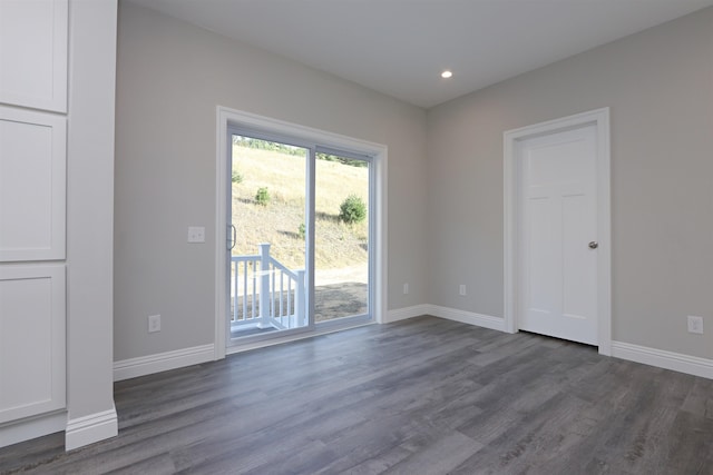 empty room with dark hardwood / wood-style flooring