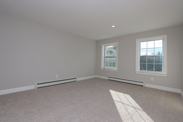 carpeted spare room with a baseboard radiator