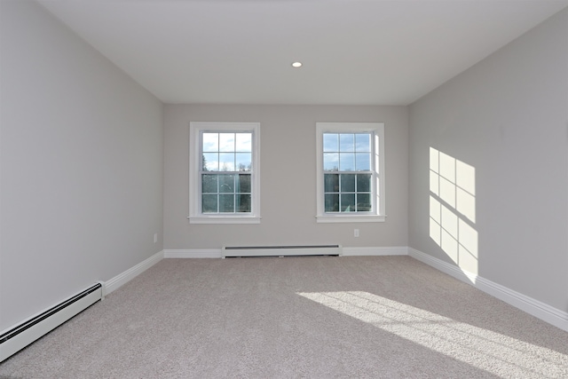 carpeted empty room with baseboard heating