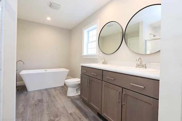 full bathroom with vanity, toilet, wood-type flooring, and plus walk in shower