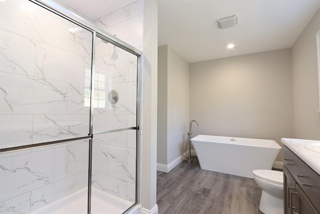 full bathroom with vanity, toilet, wood-type flooring, and shower with separate bathtub