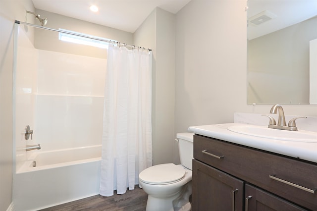 full bathroom with vanity, hardwood / wood-style floors, shower / tub combo with curtain, and toilet