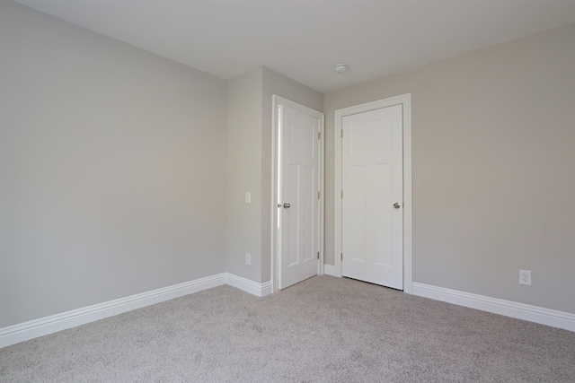 unfurnished room with light colored carpet