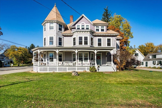 victorian-style house with a porch and a front lawn