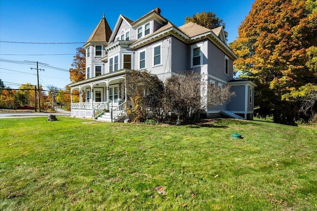 view of front of home with covered porch and a front yard