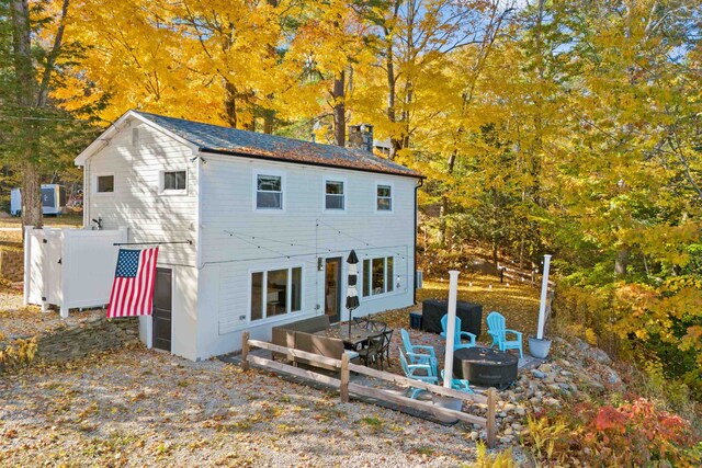 rear view of house featuring an outdoor fire pit and a deck