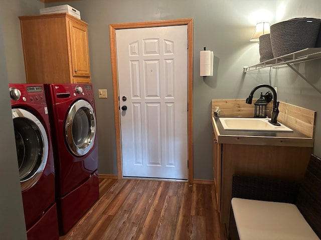 clothes washing area featuring cabinets, washer and dryer, sink, and dark wood-type flooring