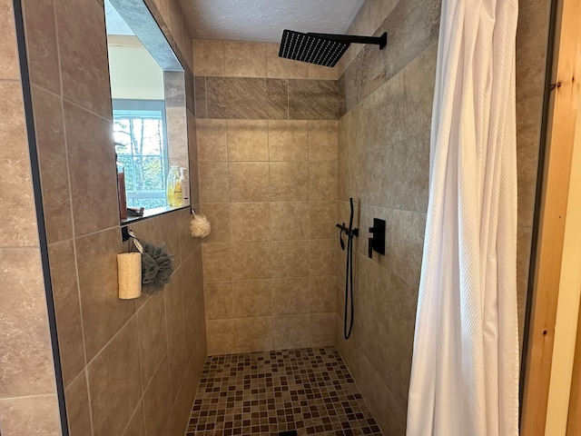 bathroom featuring walk in shower and a textured ceiling