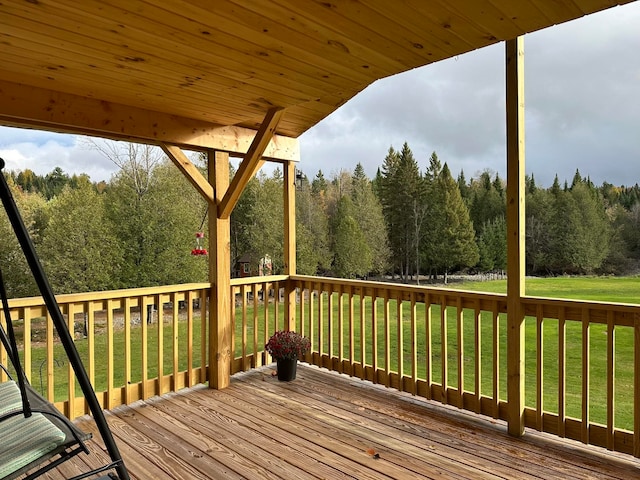 wooden deck featuring a yard