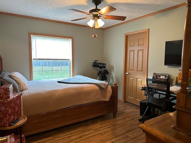 bedroom featuring ceiling fan, crown molding, a textured ceiling, and hardwood / wood-style floors