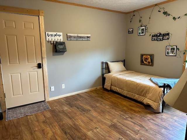 unfurnished bedroom with crown molding, hardwood / wood-style floors, and a textured ceiling