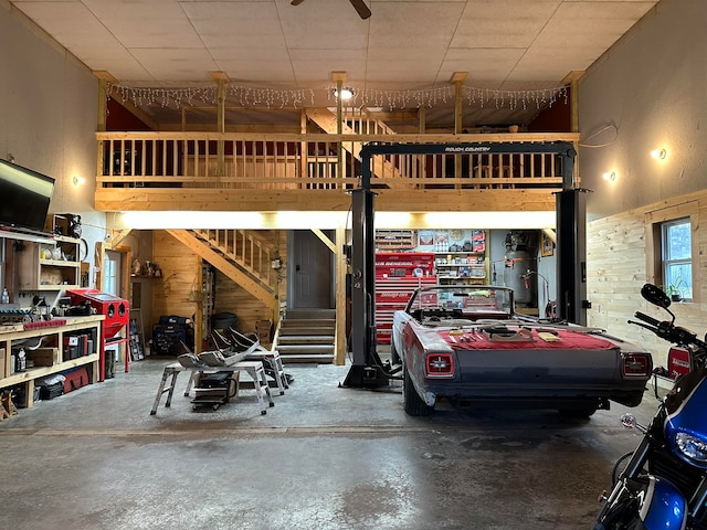 garage with wooden walls and ceiling fan