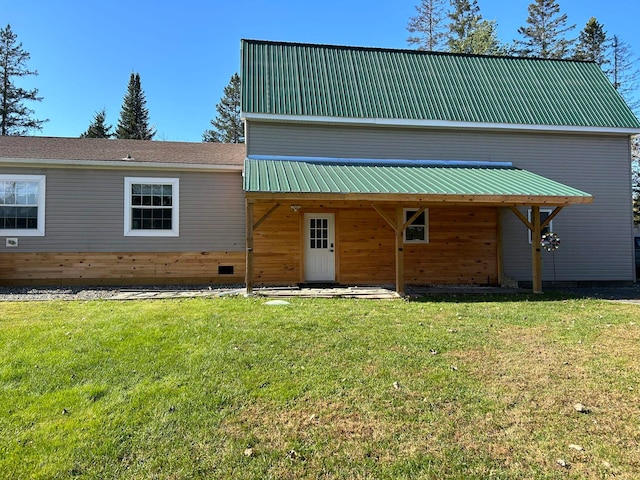 back of property featuring a lawn