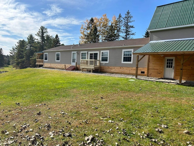 rear view of house featuring a lawn