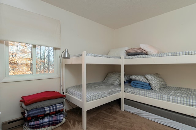 carpeted bedroom with a baseboard radiator