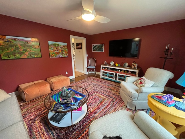 living room featuring wood-type flooring and ceiling fan