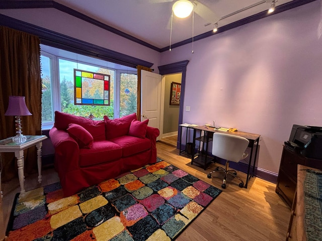 living room featuring hardwood / wood-style floors, crown molding, rail lighting, and ceiling fan