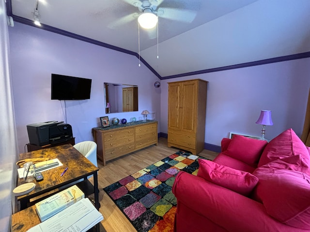 living room with ceiling fan, ornamental molding, lofted ceiling, and light wood-type flooring