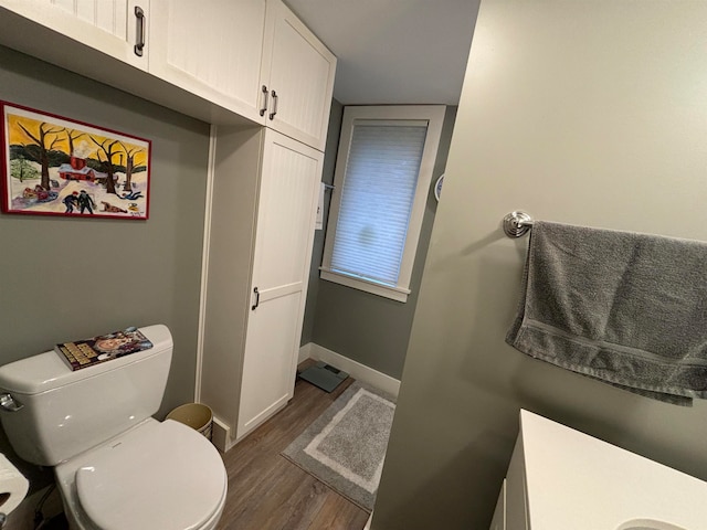 bathroom featuring vanity, toilet, and wood-type flooring