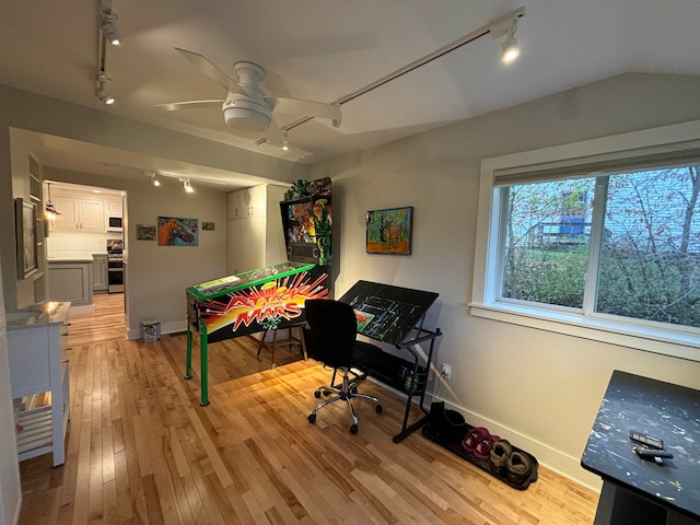 game room featuring lofted ceiling, track lighting, light hardwood / wood-style flooring, and ceiling fan