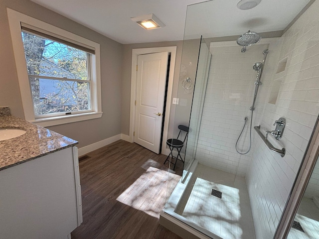 bathroom featuring a shower with door, vanity, and hardwood / wood-style flooring