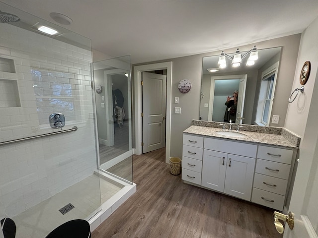 bathroom with vanity, walk in shower, and hardwood / wood-style floors