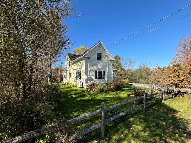 view of property exterior with a lawn