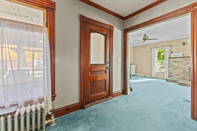 corridor featuring crown molding, radiator heating unit, and carpet floors