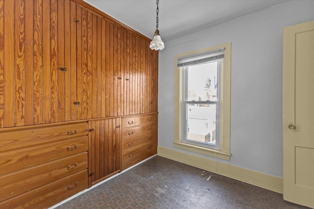 empty room featuring wooden walls