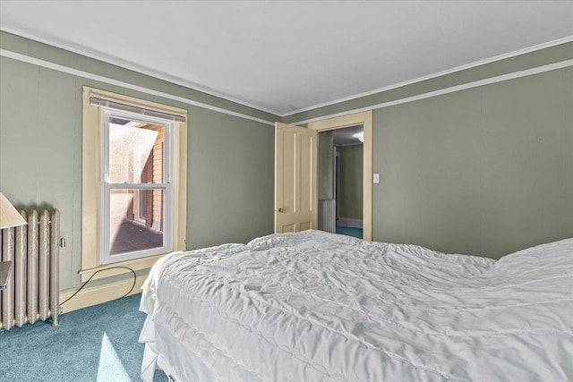 bedroom with crown molding, carpet flooring, and radiator