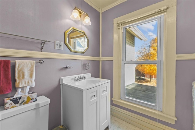 bathroom featuring vanity, crown molding, and toilet